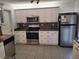 Bright kitchen with ample cabinetry, stainless steel appliances, and tile flooring at 10908 Claymont Dr, New Port Richey, FL 34654