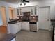 Modern kitchen featuring white cabinets, stainless steel appliances, and a tile backsplash at 10908 Claymont Dr, New Port Richey, FL 34654