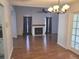 Open living room with hardwood floors, fireplace and access to patio at 10908 Claymont Dr, New Port Richey, FL 34654