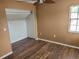 Cozy bedroom with wood-look flooring and a large closet at 10908 Claymont Dr, New Port Richey, FL 34654