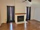 Living room with hardwood floors and a fireplace at 10908 Claymont Dr, New Port Richey, FL 34654