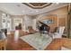 Spacious living room featuring hardwood floors, a grand piano, and ample natural light at 20617 Broadwater Dr, Land O Lakes, FL 34638