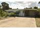 House exterior showcasing a carport and well-maintained landscaping at 5163 Tangelo Dr, New Port Richey, FL 34652