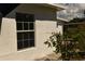 White house exterior with a multi-paned window at 5163 Tangelo Dr, New Port Richey, FL 34652