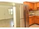 Kitchen with stainless steel refrigerator and wood cabinets at 5163 Tangelo Dr, New Port Richey, FL 34652