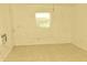 Well-lit bedroom with tile floors, window, and ceiling fan at 5163 Tangelo Dr, New Port Richey, FL 34652