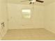 Bright bedroom featuring tile floors and a ceiling fan at 5163 Tangelo Dr, New Port Richey, FL 34652