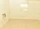 Simple bedroom with tile flooring, window, and door at 5163 Tangelo Dr, New Port Richey, FL 34652