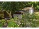 Metal storage shed nestled amongst trees at 5163 Tangelo Dr, New Port Richey, FL 34652