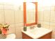 Clean bathroom with wood vanity and tiled walls at 5163 Tangelo Dr, New Port Richey, FL 34652