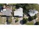 Aerial view showing a cluster of houses with surrounding greenery at 5163 Tangelo Dr, New Port Richey, FL 34652