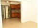 Open concept kitchen with stainless steel appliances and wood cabinets at 5163 Tangelo Dr, New Port Richey, FL 34652