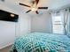 Spacious bedroom with a queen bed, ceiling fan, and ample closet space at 9641 Channing Hill Dr, Ruskin, FL 33573