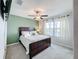 Bedroom with a king bed, ceiling fan, and accent wall at 9641 Channing Hill Dr, Ruskin, FL 33573