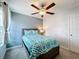 Bright bedroom with a double bed, ceiling fan, and large window at 9641 Channing Hill Dr, Ruskin, FL 33573