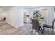 Modern dining area with gray chairs, and an open view to the kitchen at 8780 53Rd Way, Pinellas Park, FL 33782