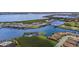 Wide aerial showcasing waterfront lot and home location at 1702 4Th E St, Palmetto, FL 34221