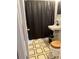 Clean bathroom with black shower curtain and tiled floor at 8112 Alpine Ave, Tampa, FL 33619