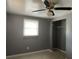 Spacious bedroom with a large window, ceiling fan, and walk-in closet at 8112 Alpine Ave, Tampa, FL 33619