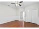 Bedroom with hardwood floors, ceiling fan, and access to bathroom at 10616 Cape Hatteras Dr, Tampa, FL 33615