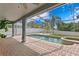 Inviting pool and spa with covered patio and string lights at 10616 Cape Hatteras Dr, Tampa, FL 33615