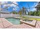 Relaxing screened pool area with spa and firepit at 10616 Cape Hatteras Dr, Tampa, FL 33615