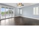 Bedroom with dark hardwood floors and sliding doors to balcony at 10616 Cape Hatteras Dr, Tampa, FL 33615