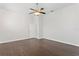 Spacious bedroom with hardwood floors, ceiling fan, and an adjacent bathroom at 10616 Cape Hatteras Dr, Tampa, FL 33615