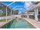 Inviting pool area with covered patio, spa, and brick pavers at 10616 Cape Hatteras Dr, Tampa, FL 33615