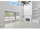 Two-story living room with fireplace, built-in shelving and hardwood floors at 10616 Cape Hatteras Dr, Tampa, FL 33615