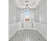 Bright entryway with white door, chandelier, and wood-look floors at 10616 Cape Hatteras Dr, Tampa, FL 33615