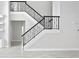 Modern staircase with black metal railing and white risers at 10616 Cape Hatteras Dr, Tampa, FL 33615
