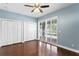 Bright bedroom with hardwood floors, double doors and sliding doors to backyard at 10616 Cape Hatteras Dr, Tampa, FL 33615