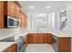 Modern kitchen with stainless steel appliances and wood cabinets at 10616 Cape Hatteras Dr, Tampa, FL 33615