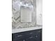 Stylish bathroom features a dark vanity, herringbone tile, and a large mirror at 10616 Cape Hatteras Dr, Tampa, FL 33615