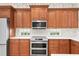 Modern kitchen with double oven and wood cabinets at 10616 Cape Hatteras Dr, Tampa, FL 33615