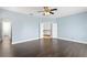 Large bedroom with dark hardwood floors and light blue walls at 10616 Cape Hatteras Dr, Tampa, FL 33615