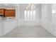 Bright dining room with chandelier, hardwood floors, and white wainscoting at 10616 Cape Hatteras Dr, Tampa, FL 33615