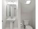 Small bathroom with pedestal sink, toilet, and updated fixtures at 10616 Cape Hatteras Dr, Tampa, FL 33615