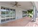 Covered patio with brick pavers, ceiling fan, and sliding glass doors at 10616 Cape Hatteras Dr, Tampa, FL 33615