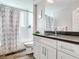 Clean bathroom with modern vanity and shower/tub combo at 156 175Th E Ave, Redington Shores, FL 33708