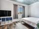 Bright bedroom with a queen bed, TV, and modern decor at 156 175Th E Ave, Redington Shores, FL 33708