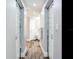 Bright hallway with modern doors leading to bathrooms at 156 175Th E Ave, Redington Shores, FL 33708
