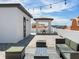 Relaxing rooftop patio with seating, string lights, and city views at 156 175Th E Ave, Redington Shores, FL 33708