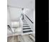Modern staircase with dark wood treads and white risers at 156 175Th E Ave, Redington Shores, FL 33708