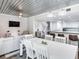Open dining area with a white table and chairs, near the living room at 156 175Th E Ave, Redington Shores, FL 33708