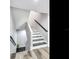 Modern staircase with dark wood treads and white risers at 156 175Th E Ave, Redington Shores, FL 33708