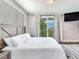 Bedroom with king-size bed and access to a private balcony at 156 175Th E Ave, Redington Shores, FL 33708