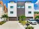 Modern two-unit building with attached garages and landscaping at 156 175Th E Ave, Redington Shores, FL 33708