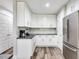 Additional kitchen area with white cabinets and stainless steel appliances at 156 175Th E Ave, Redington Shores, FL 33708